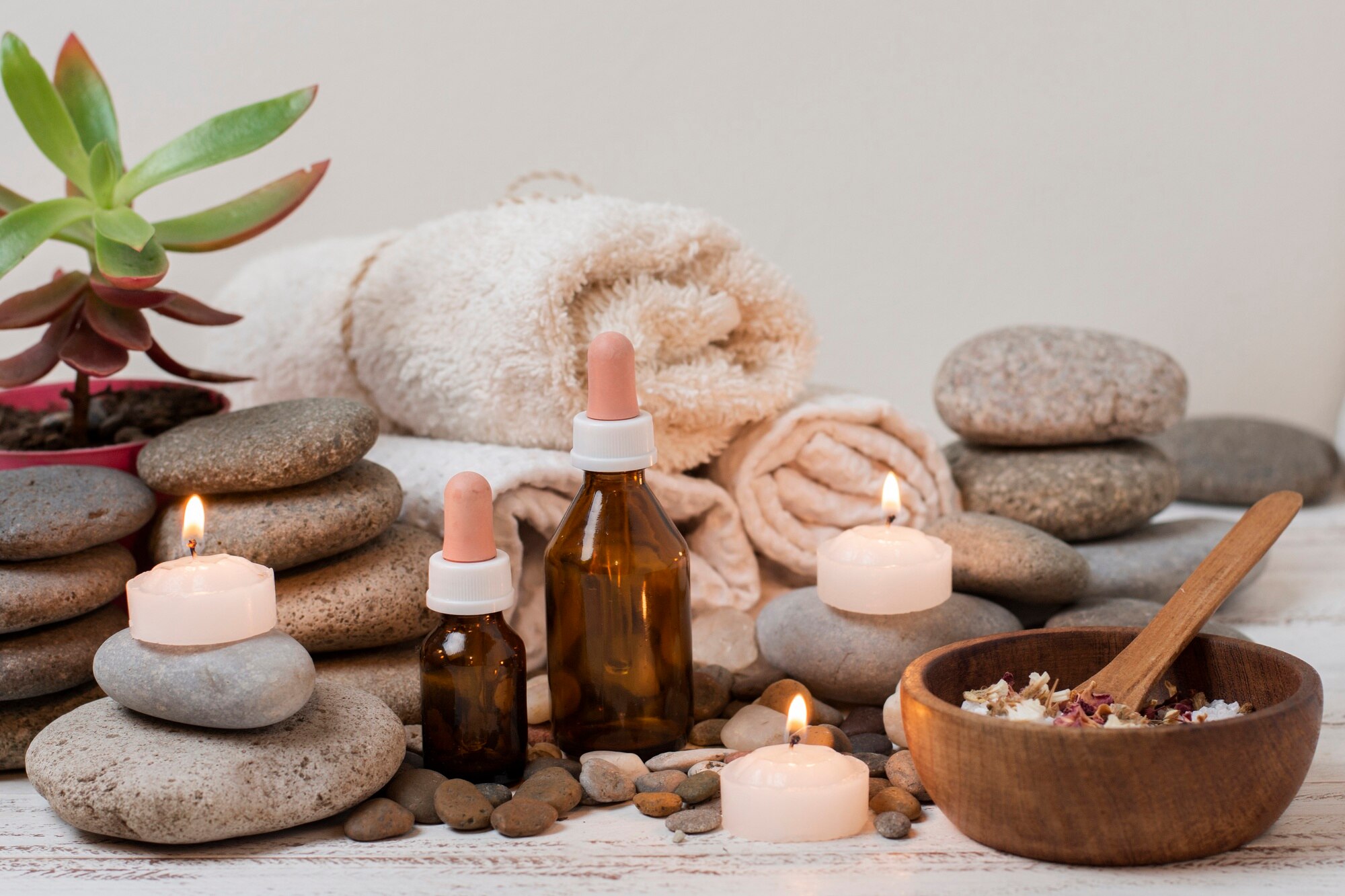 Relaxing setup at a day spa in Altamonte Springs, FL, showing essential oils, stones, and lit candles.